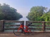 Cyclist traversing Kerala coastline